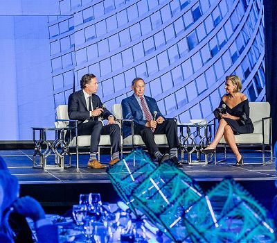 Three event speakers on the main stage.