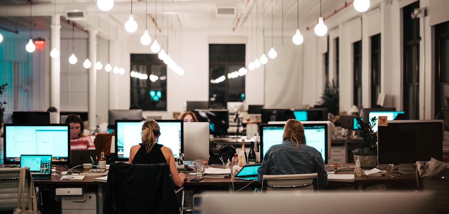 Open office with workers at their desks.