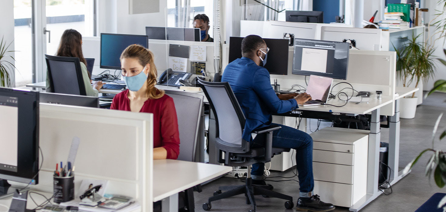 Masked workers in an office.