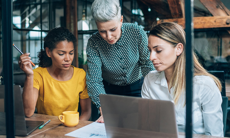 3 professional women collaborating.