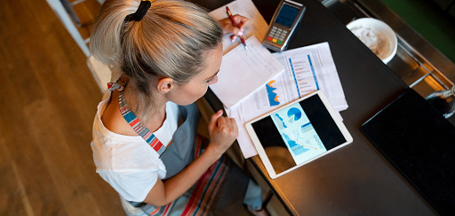 Woman working with computer and calculator