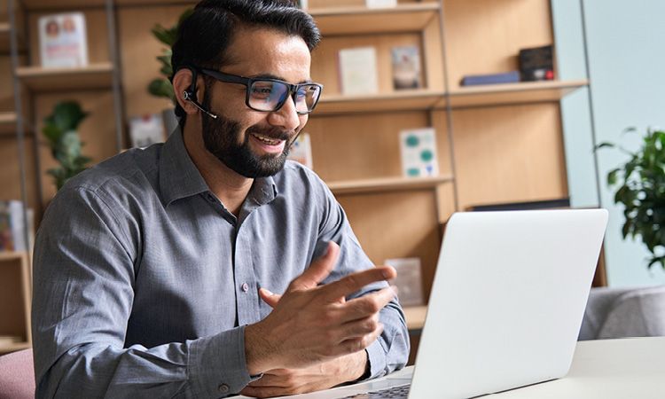 Man on laptop during a call. 