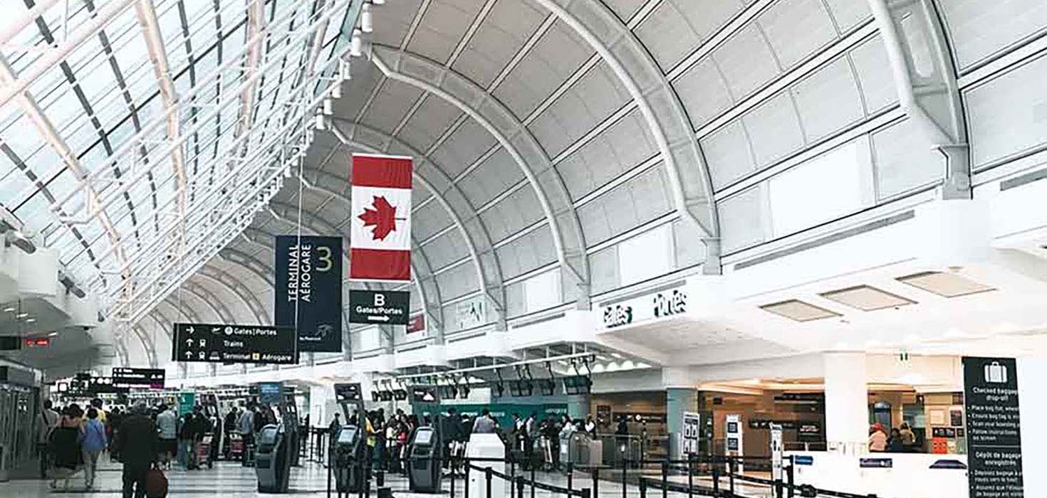 A bright airport terminal filled with light.